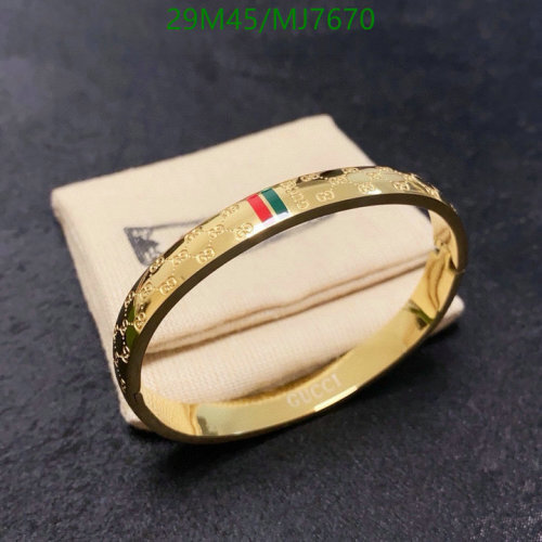 Gucci Gold-Tone Bangle with Iconic GG Monogram and Striped Detail